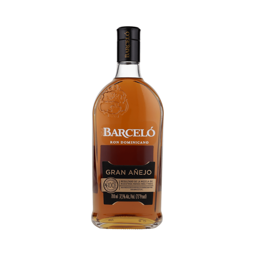 A bottle of Barceló Gran Añejo rum spirit on a plain white background. The clear glass bottle shows the amber-brown liquid inside, with a black cap and a label featuring white and gold text.